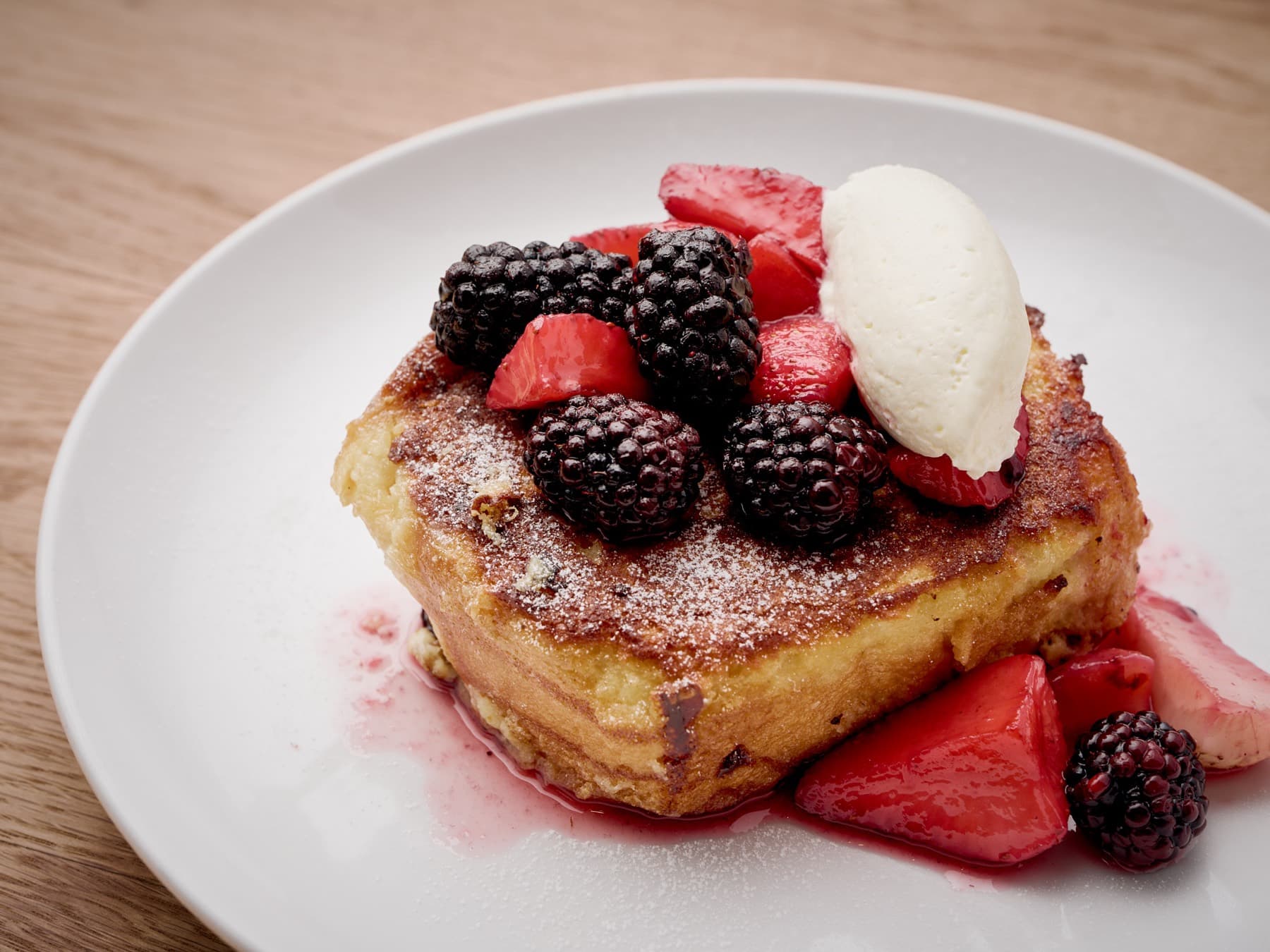 Brioche French toast with blackberries, strawberries, and whipped cream