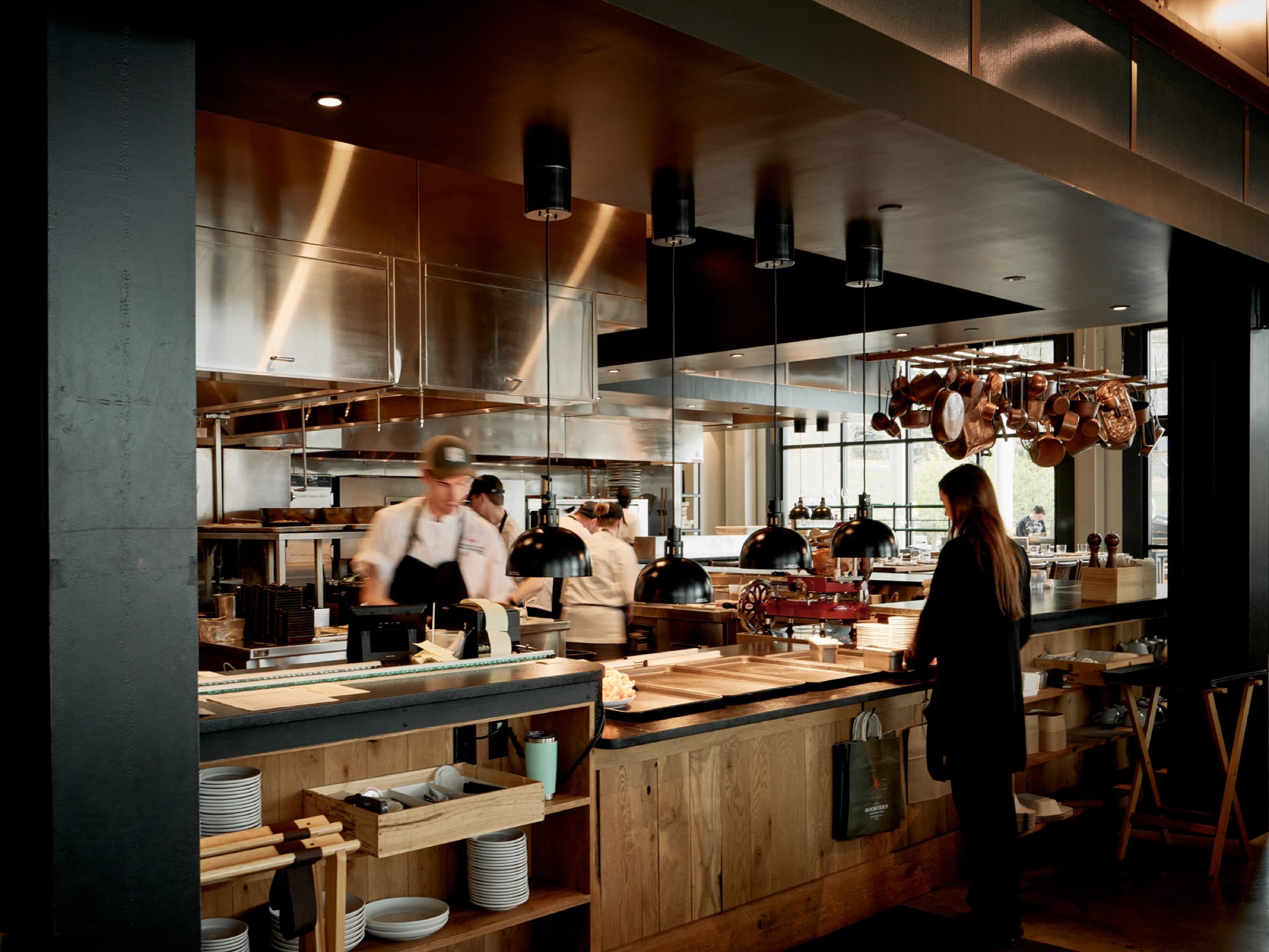The open kitchen at Rooster's Ballantyne with copper pans